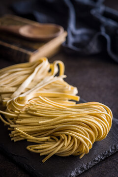Fresh pasta ready for cooking, showing strands of bigoli set on a black background