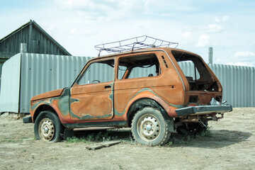 An abandoned burnt-out, rusty car after the explosion, ready for disposal. The burnt-out interior of the car, a close-up of the fire, extinguishing the fire. A burnt-out car, due to a short circuit. 