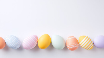 Fototapeta premium Pastel Easter eggs border on white background, minimalist spring holiday composition