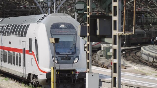 Passenger train departs from central Hauptbahnhof station in Cologne, Germany, slow motion