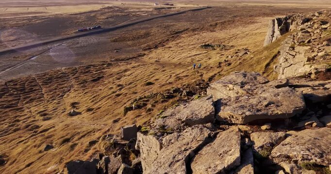 Group of people scientists checking a volcanic terraing in the incredible lava wild landscape in Iceland on explorer expedition