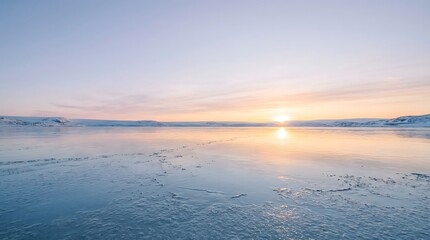 Fototapeta premium Serene sunset over calm frozen lake with ice and snow at dawn