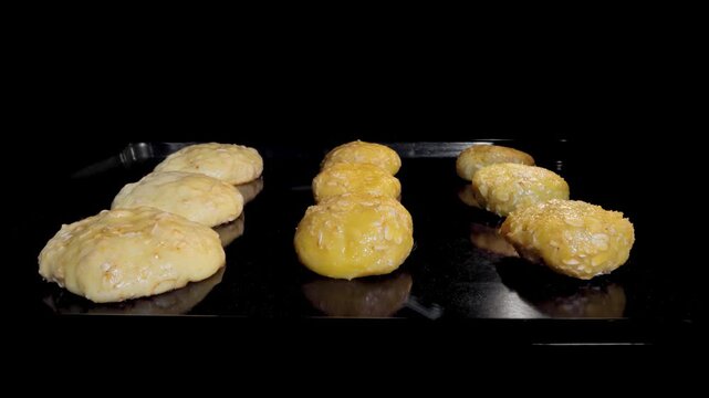 Timelapse - process of cooking nine homemade crunchy oatmeal cookies in row on metal sheet in oven - front view, loop, cinemagraph. Time lapse, dessert, baking, gastronomy and food concept