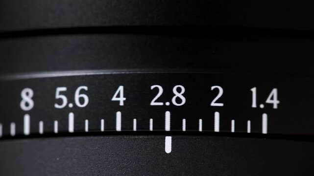 close up shot of a camera lens aperture ring cycling from f/1.4 through to f/16.
