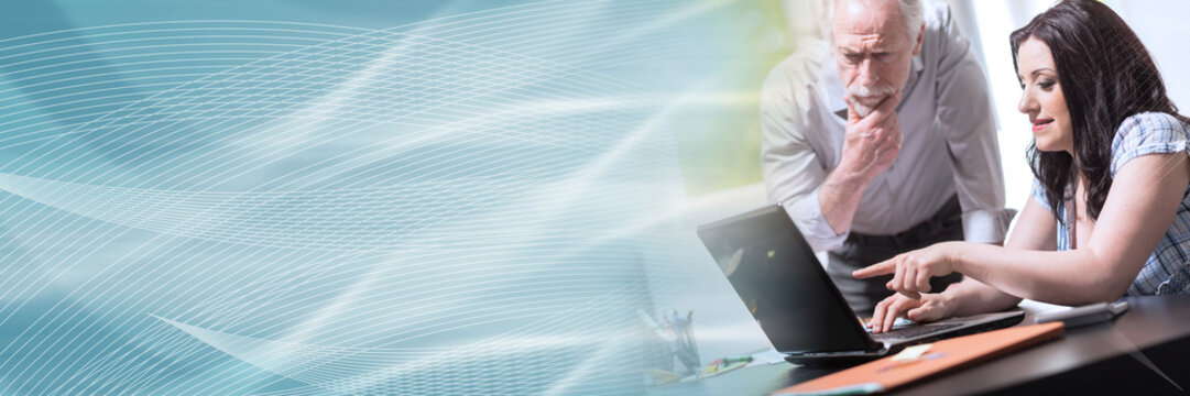 Young businesswoman and senior businessman working together, light effect; panoramic banner