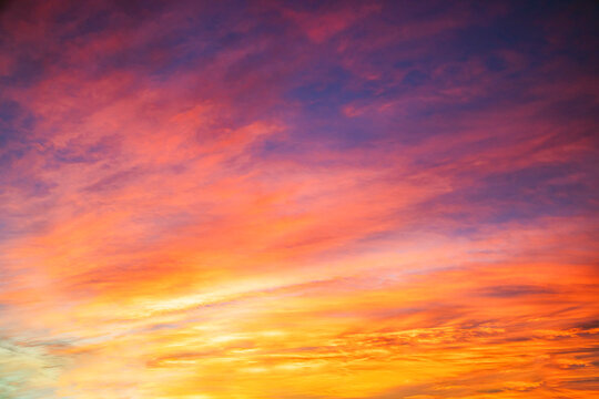 Pastel sunrise sky with pink lavender clouds and warm golden horizon glow