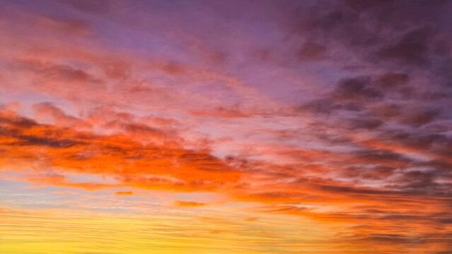 Winter sunrise fill the winter sky with dramatic colors of orange, yellow, purple and blue, creating a warm and colorful sky just before the sunrises.
