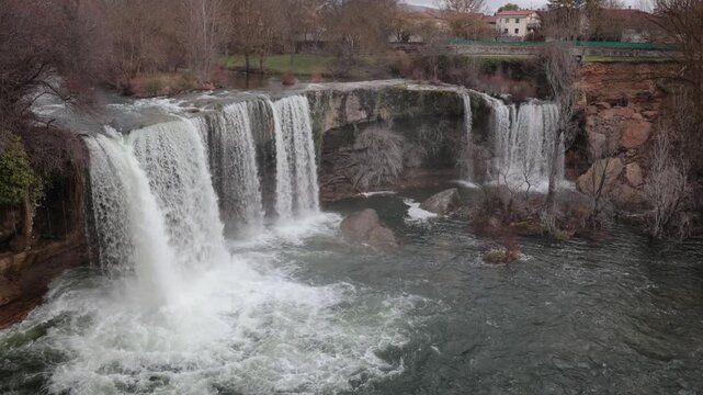 Jerea river waterfall showing the powerful flow of water over the rocky cascade in pedrosa de tobalina