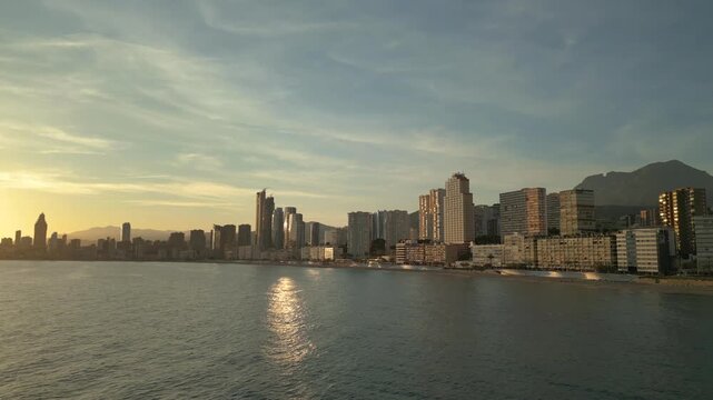 Benidorm skyline sunset with golden hour reflection