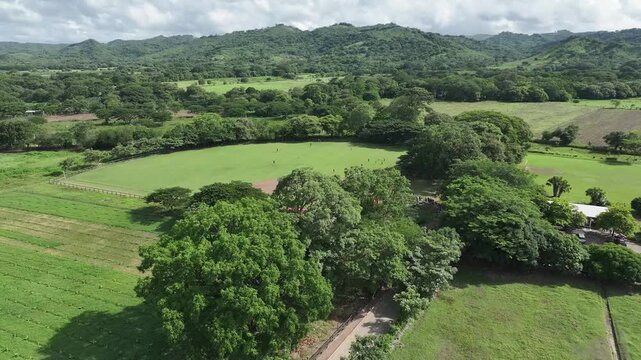 Aerial Drone View of Rural Baseball Field Surrounded by Lush Green Hills in Nicaragua