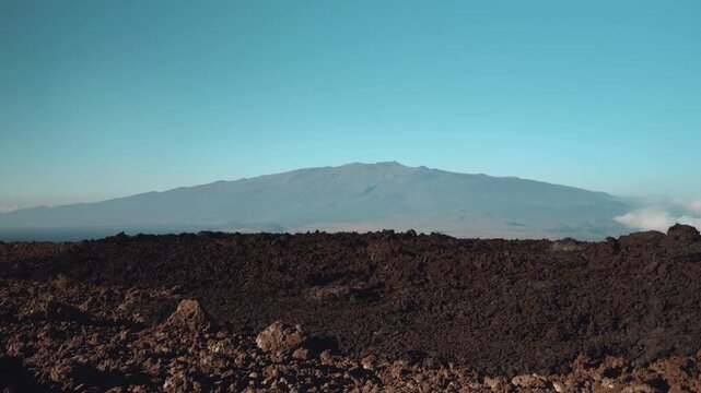 Tholeiitic basalt Lava flows (Kau Basalt) from Earth's largest active volcano Mauna Loa (Shield volcano). Pu'u Huluhulu, The Big Island (Hawaiʻi Island). Mauna Kea is in the distance.


