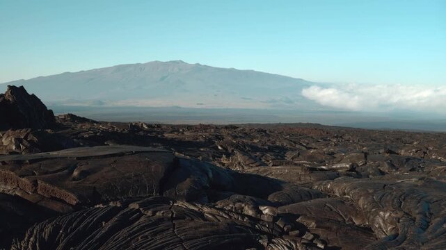 Tholeiitic basalt Lava flows (Kau Basalt) from Earth's largest active volcano Mauna Loa (Shield volcano). Pu'u Huluhulu, The Big Island (Hawaiʻi Island). Mauna Kea is in the distance.


