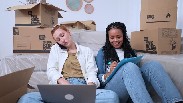 Two women organizing a move in their new apartment