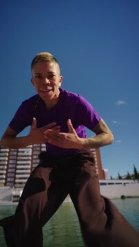 Non binary person voguing and dancing outdoors in slow motion