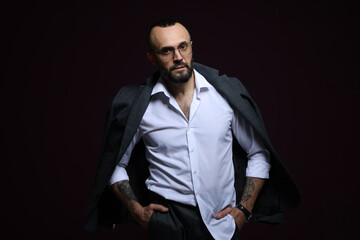 Fototapeta premium Fashion model. Handsome man with jacket on black background