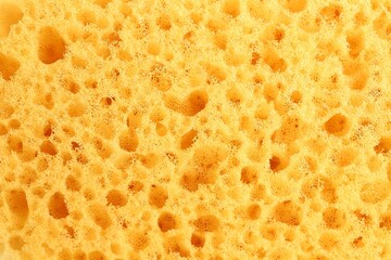 Yellow sponge as background, closeup. Shower accessory