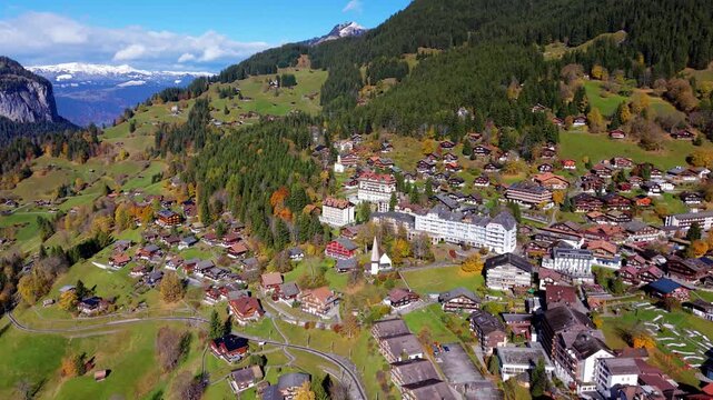 Wengen village aerial view situated on a mountain shelf with majestic alpine backdrop. Wengen, Canton of Bern, Switzerland