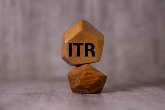 Wooden blocks with the inscription ITR income tax return on office desk