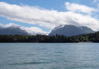 Blue cloudy sky over snow covered mountains and Kachemak Bay in Homer Alaska United States