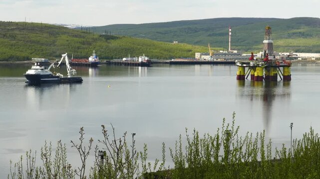 Murmansk, Russia - June 25, 2017: Ships and a Chinese floating drilling rig in the Kola Bay. Barents Sea, Gulf Stream.
