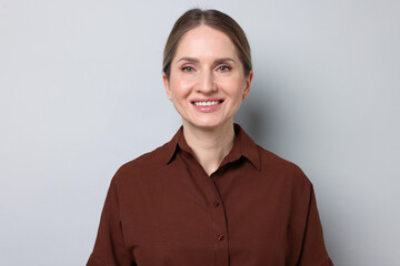Fototapeta premium Portrait of beautiful woman on light grey background