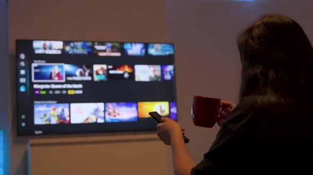 Person browsing streaming service on smart tv at home