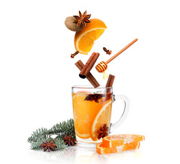 Mulled wine recipe. Spices and other ingredients falling into glass cup with beverage against white...