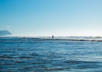 Fototapeta premium Person fishing on the beach