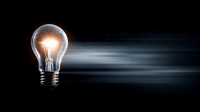 Illuminating Idea Glowing Light Bulb Symbolizing Innovation and Bright Concepts on a Dark, Blurred Background