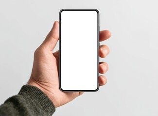 A hand holds a rectangular touchscreen smartphone with a bright white display against a grey backdrop