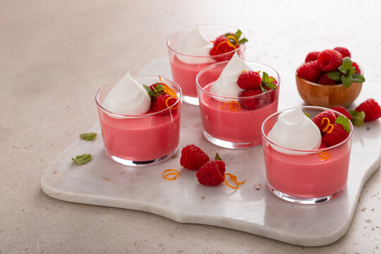 Raspberry yogurt parfait with whipped topping and fresh raspberries, high protein dessert
