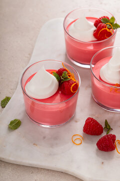 Raspberry yogurt parfait with whipped topping and fresh raspberries, high protein dessert