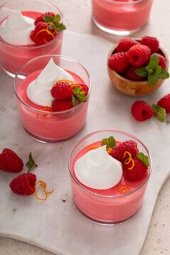 Raspberry yogurt parfait with whipped topping and fresh raspberries, high protein dessert