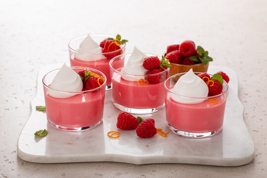 Raspberry yogurt parfait with whipped topping and fresh raspberries, high protein dessert