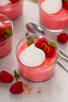 Raspberry yogurt parfait with whipped topping and fresh raspberries, high protein dessert