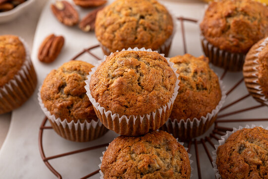 Banana muffins with pecan nuts freshly baked on a cooling rack