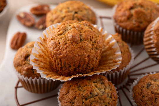 Banana muffins with pecan nuts freshly baked on a cooling rack