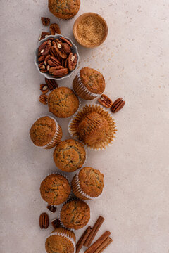 Banana muffins with pecan nuts freshly baked on a cooling rack overhead with copy space