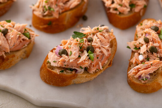 Hot smoked salmon crostini with smoked or roasted salmon, red onion and capers