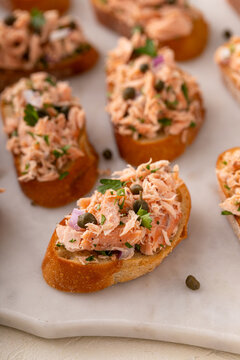 Hot smoked salmon crostini with smoked or roasted salmon, red onion and capers