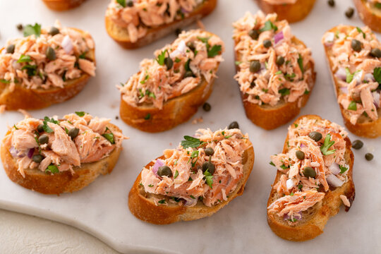 Hot smoked salmon crostini with smoked or roasted salmon, red onion and capers