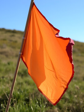 The Fading Colors: A tattered flag, once waving proudly, now hanging limply in the breeze
