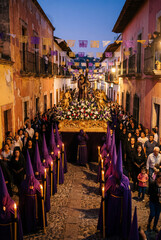 Obraz premium Semana Santa Night Procession with Purple Penitents and Baroque Float in Colonial Mexican Street – Holy Week, Candlelight, Taxco, Catholic Tradition and Cultural Heritage