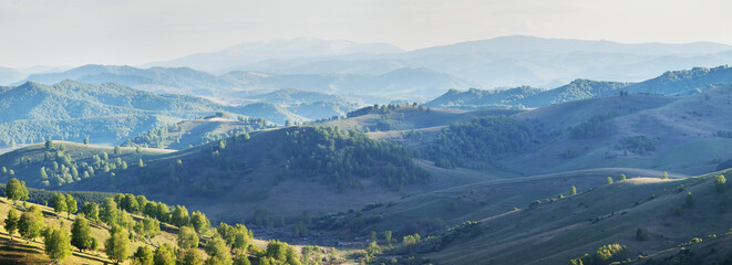 View of the evening haze, hills and mountain slopes in sunset light, panoramic view