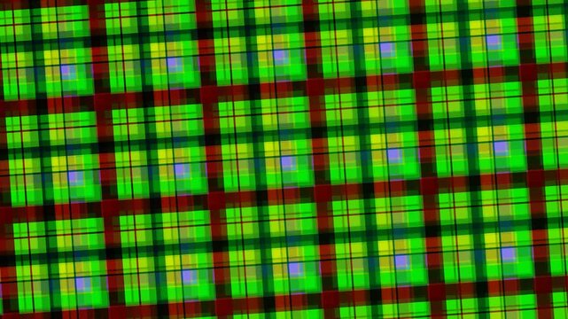 A close-up view of a vibrant green, red, and yellow plaid pattern with a grid-like design on a white background.