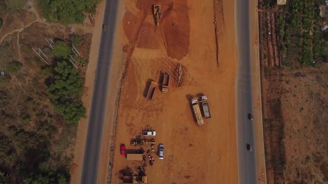 Top down aerial of heavy equipment on the construction site of a newly developed road in Apo Gudu area of Abuja, FCT, Nigeria