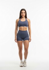 Fototapeta premium Athletic woman wearing a sports bra and shorts on a white background