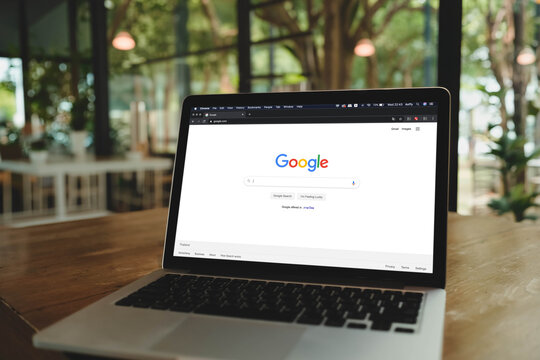 Bangkok, Thailand. March 4, 2026; A MacBook Pro on a wooden table displaying the Google search engine home page in a lush, garden-themed cafe.