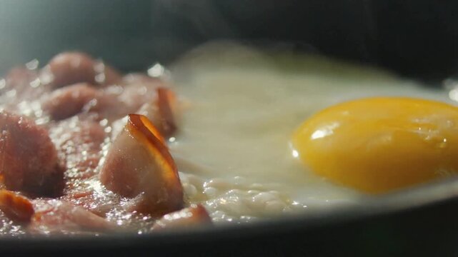 A hot frying pan with freshly fried eggs and bacon slices. served nourishing balanced breakfast, morning meal preparation. Cooking Eggs and Bacon.