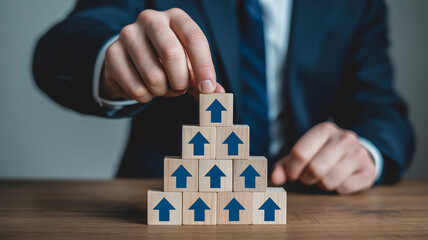 Businessman building success with upward arrow blocks